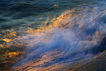 Small waves breaking on rocks at sunset, Kallskr, Stockholm Archipelago, Sweden, June 2009