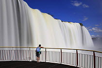 Man on viewing platform watching the Iguazu waterfall, Iguaçu National Park, Brazil
