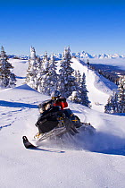 Snowmobiling in the Bridger - Teton National Forest on Togwotee Pass near Dubois, Wyoming. Model released, January 2009