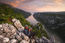 Photographer, Ruben Smit, above the River Danube flowing through the Iron Gate Gorge, on the border between Romania and Serbia, Djerdap National Park, Serbia, June 2009