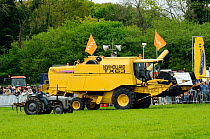 Vintage 1930s tractor next to modern combine harvester at North Somerset show, Wraxall, Nr Bristol, UK. May 2009