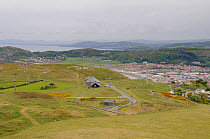 View of the Great Orme limestone headland showing cable cars and Llandadno town in distance, Conwy, North Wales, UK, May