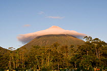 Arenal Volcano with crown of clouds around the summit at sunrise, La Fortuna, Costa Rica, February 2009