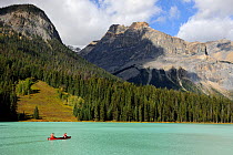 Two people canoeing on Emerald Lake, Yoho National Park, Rocky Mountains, British Columbia, Canada, September 2009