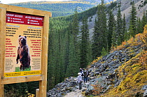 Bear sign stating official park safety information and regulations regarding bear encounters, Banff National Park, Rocky Mountain, Alberta, Canada, September 2009