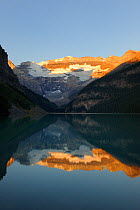 Lake Louise at sunrise with moutains reflected in water, Banff National Park, Rocky Mountains, Alberta, Canada, September 2009