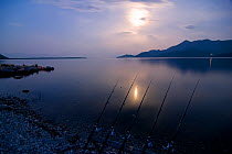 Fishing rods at the edge of Lake Skadar at night, Lake Skadar National Park, Montenegro, May 2008