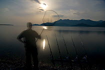 Fisherman and fishing rods on Lake Skadar at night, Lake Skadar National Park, Montenegro, May 2008