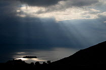 Sun shining through clouds over Lake Skadar near Murici, Lake Skadar National Park, Montenegro, May 2008