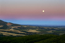 Moon rising over the Somontano lowlands at dusk, Aragon, Spain.