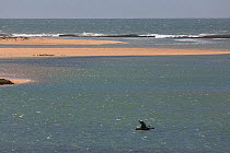Man fishing from small boat in the Sidi-Moussa Lagoons on the Atlantic coast, Morocco. March 2007.