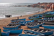 Fishing boats pulled up on beach, Souss-Massa National Park, Morocco. March 2007.
