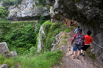 People hiking though Desfiladero gorge, de Les Xanes, Somiedo Natural Reserve, Asturias, Spain. July 2008.