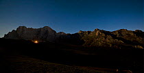 Aliva valley with the mountain refuge lit up at 3am, Picos de Europa National Park, Cantabria, Spain. July 2008.