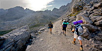 Hikers on footpath, Picos de Europa National Park, Cantabria, Spain. July 2008.