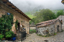 Traditional buildings and sett-paved road in the isolated village of Bulnes, only accessible by cable car. Picos de Europa National Park, Cantabria, Spain. July 2008.