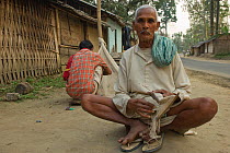Assamese fisherman sewing fishing nets in village near Dibru river, Tinsukia, Assam, India March 2009