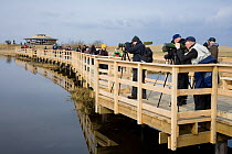 People visiting wetland visitor centre at Lake Hornborga during spring migration of Eurasian Cranes (Grus grus), Sweden, April 2008