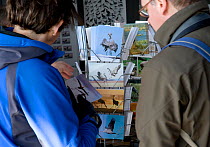 People buying postcards at visitor centre at Lake Hornborga during spring migration of Eurasian Cranes (Grus grus), Sweden. April 2008