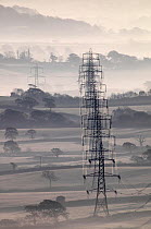 Electricity pylons stretching across the Marshwood Vale in west Dorset, Lambert's Castle, Marshwood, Dorset, England, December