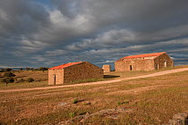 Ruined barns with a thunderstorm approaching, nesting habitat of Hoopoes and Spotless starlings, Castelo Branco, Portugal