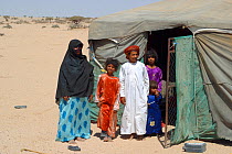 Bedouin mother with children near their tent in the desert, Oman, February 2003