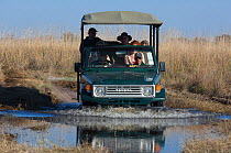 Tourist vehicle crossing river, Khwai, Okavango Delta, Moremi reserve, Botswana