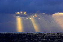 Rays of light shining through storm clouds over Drake Passage, Antarctica, February 2006