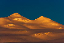 Snow covered mountains at sunset, King Haakon Bay, South Georgia, December 2006