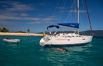Couple snorkelling near a Sunsail Oceanis 423 in the BVI, March 2006. Model and property released.