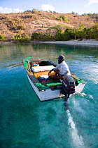 Local fisherman in wooden motorboat off the BVI. April 2006.