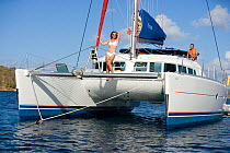 Woman on the bow of a Sunsail Lagoon 410 anchored in the BVI. April 2006.