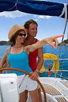 Couple helming a Sunsail yacht in the British Virgin Islands, March 2006. Model and property released.