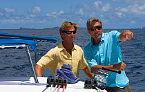 Two men sailing a Sunsail yacht in the British Virgin Islands, March 2006. Model and property released.