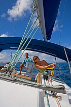 Couple sailing a Sunsail yacht in the British Virgin Islands, March 2006. Model and property released.