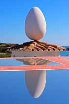 Egg-shaped sculpture balanced on roof and refelected in water at Salvador Dali's House-Museum. Port Lligat, Cap de Creus Natural Park, Gerona, Catalonia, Spain. March 2009.