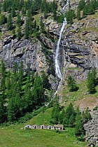 Waterfall and shepherd's house and stables, Valsavarenche Valley, Gran Paradiso National Park, Alps, Italy, July 2009