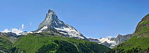 Panoramic view of the Matterhorn (4,478m) with alpine meadows and pine forests, Valais, Switzerland, July 2009