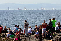 Spectators on rocks at Salthill, watching the Volvo Ocean Race Inshore Races, Galway, Ireland, May 2009.