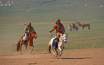 Two mounted soldiers from the armies of Genghis Khan (emperor of the Mongol Empire) during the Genghis Khan Show, in Ulaanbaatar, Mongolia. The horses are Mongolian horses. July 2007