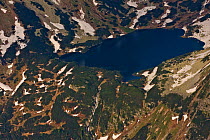 Aerial view of the Temnosmrecianske lake and waterfall at sunset, High Tatras, Carpathian Mountains, Slovakia, June 2009