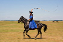 Typical Hungarian herdsman's riding ritual with a whip, Hortobagy National Park, Hungary, May 2009