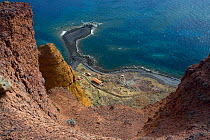 View of buildings on the coast from cliff top, Deserta Grande, Desertas Islands, Madeira, Portugal, August 2009
