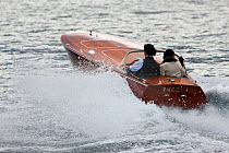 Classically dressed couple on Riva motorboat. Monaco Classic Week, September 2009.