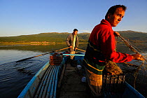 Two fishermen in a boat on Lake Prespa, Lake Prespa National Park, Albania, June 2009
