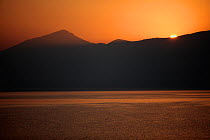 Sunrise over Mount Golema (2,179m) and Mount Pelister (2,600m) Pelister National Park, viewed from Stenje village across Lake Macro Prespa, Macedonia, June 2009