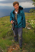 Photographer, David Maitland, holding camera near Lake Ohrid, Galicica National Park, Macedonia, June 2009