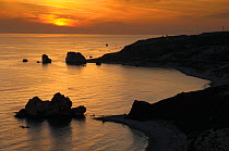 Petra tou Romiou (Aphrodites Rock) silhouetted at sunset, Pissouri Bay, near Paphos, Cyprus, March 2009