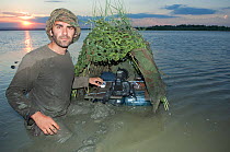 Photographer, Laurent Geslin, in lake with floating hide, Lake Belau, Moldova, June 2009. WWE OUTDOOR EXHIBITION.