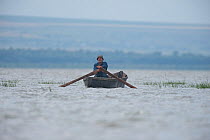 Man rowing boat on lake, Lake Belau, Moldova, June 2009